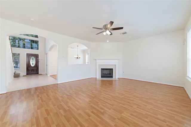 a view of empty room with wooden floor and fireplace