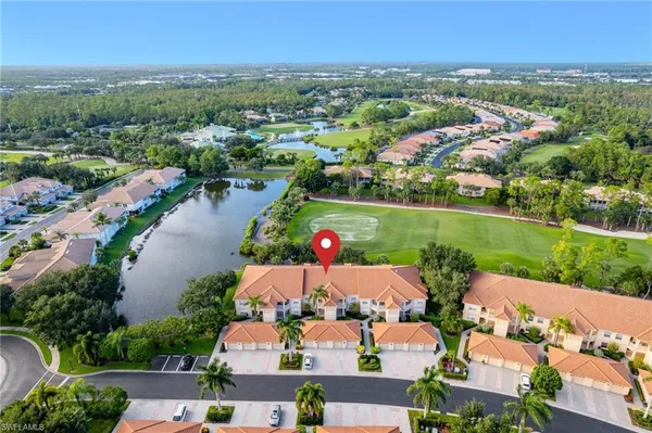 an aerial view of residential houses with outdoor space and river