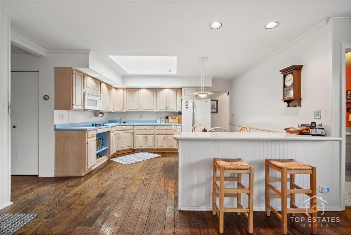 1802 Aspen Drive Mount Prospect, IL 60056 - Photo 12 of 30 a kitchen with a table chairs sink and cabinets