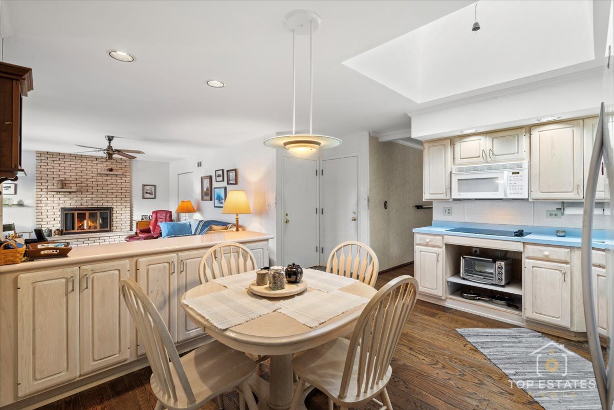 1802 Aspen Drive Mount Prospect, IL 60056 - Photo 15 of 30 a view of a dining room with furniture and a fireplace