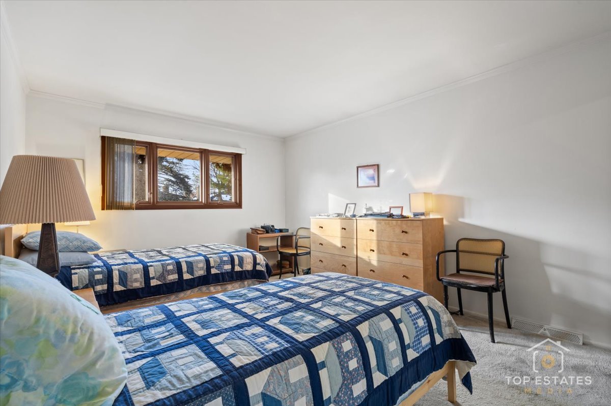 1802 Aspen Drive Mount Prospect, IL 60056 - Photo 17 of 30 a bedroom with a bed and wooden floor