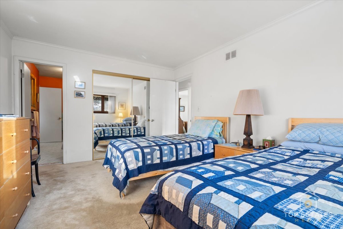 1802 Aspen Drive Mount Prospect, IL 60056 - Photo 18 of 30 a bedroom with two beds and a lamp