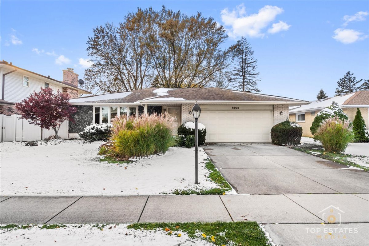 1802 Aspen Drive Mount Prospect, IL 60056 - Photo 2 of 30 a view of a white house with a large tree