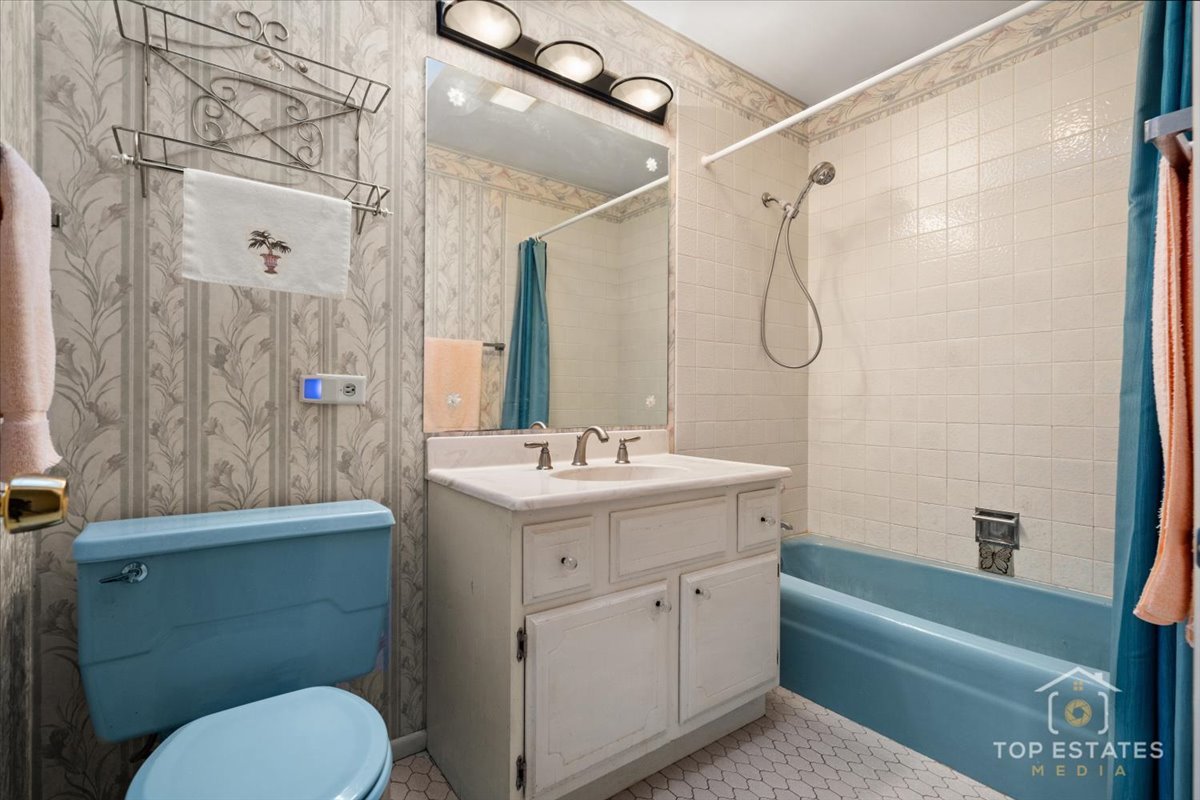 1802 Aspen Drive Mount Prospect, IL 60056 - Photo 22 of 30 a bathroom with a sink a toilet and shower