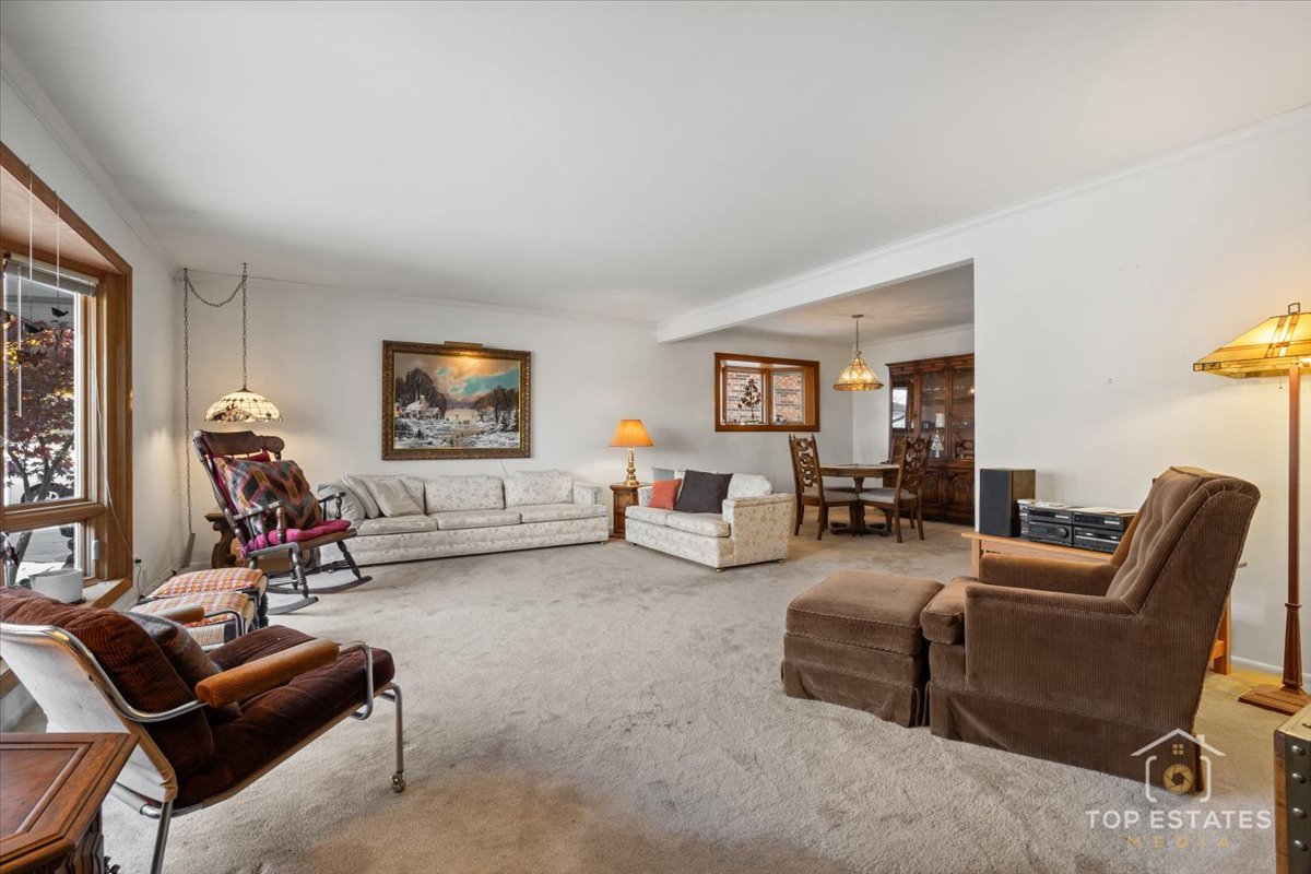 1802 Aspen Drive Mount Prospect, IL 60056 - Photo 5 of 30 a living room with furniture a flat screen tv and a window