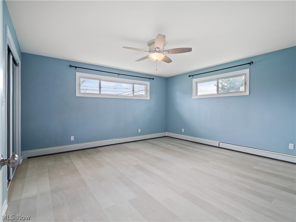 19155 Drake Road Strongsville, OH 44149 - Photo 15 of 29 Spare room featuring a healthy amount of sunlight, ceiling fan, and light wood-type flooring