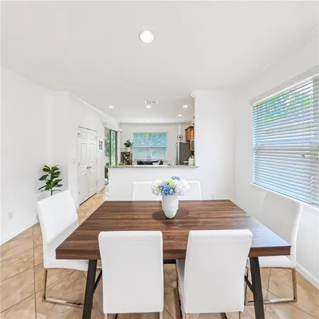 a dining room with kitchen island a table and chairs