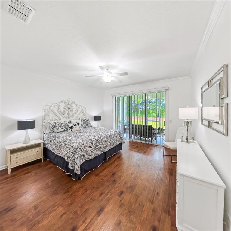 9117 Southwest 70th Loop Ocala, FL 34481 - Photo 15 of 24 a bedroom with a bed and a large window