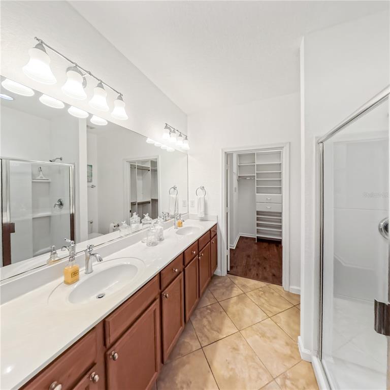 9117 Southwest 70th Loop Ocala, FL 34481 - Photo 17 of 24 a spacious bathroom with a double vanity sink mirror and shower