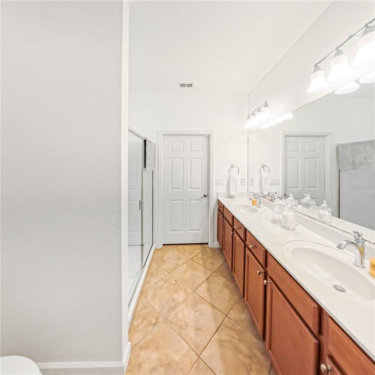 9117 Southwest 70th Loop Ocala, FL 34481 - Photo 19 of 24 a spacious bathroom with a granite countertop sink mirror and a