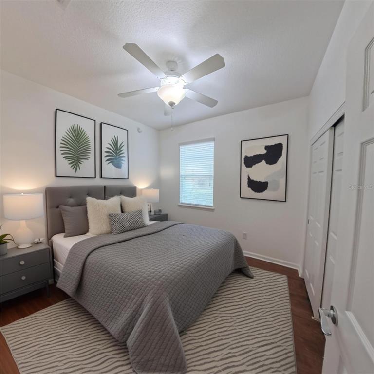 9117 Southwest 70th Loop Ocala, FL 34481 - Photo 21 of 24 a bedroom with a large bed and a chandelier