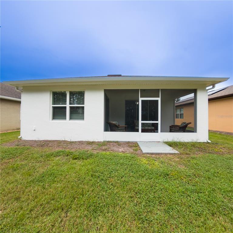 9117 Southwest 70th Loop Ocala, FL 34481 - Photo 4 of 24 a view of a house with a garden