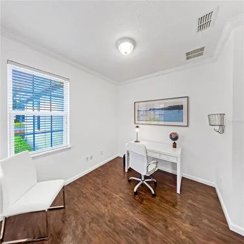 a workspace with wooden floor and a window