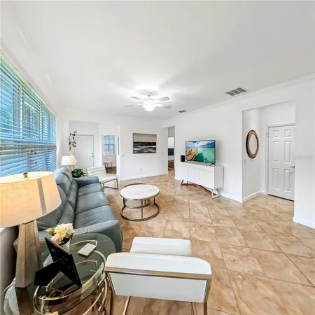 a living room with furniture and a wooden floor