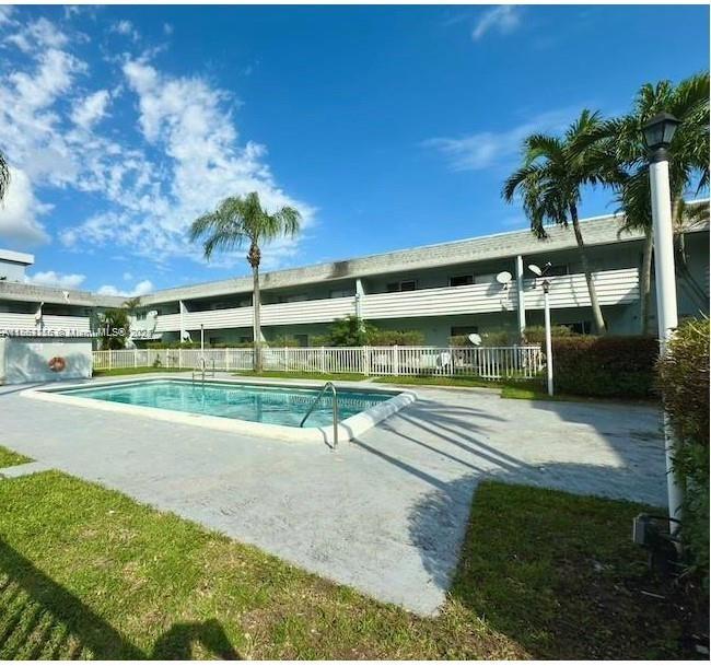 4271 Northwest 5th Street, Unit 108 Plantation, FL 33317 - Photo 6 of 6 a view of a swimming pool with an outdoor space and seating area