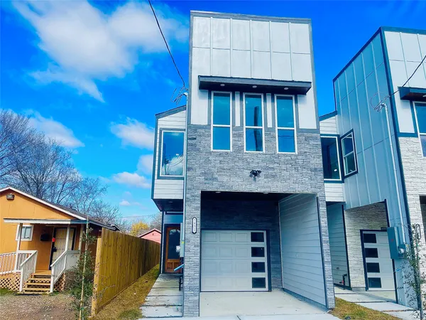a view of a white building with many windows