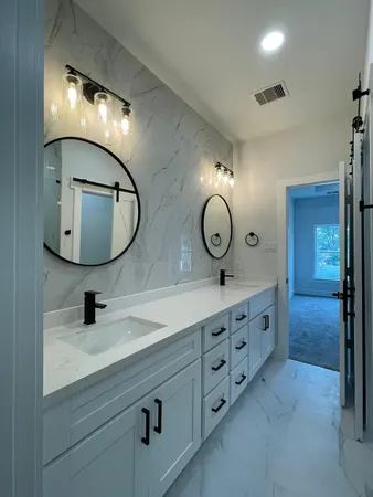 a bathroom with a granite countertop shower and a toilet