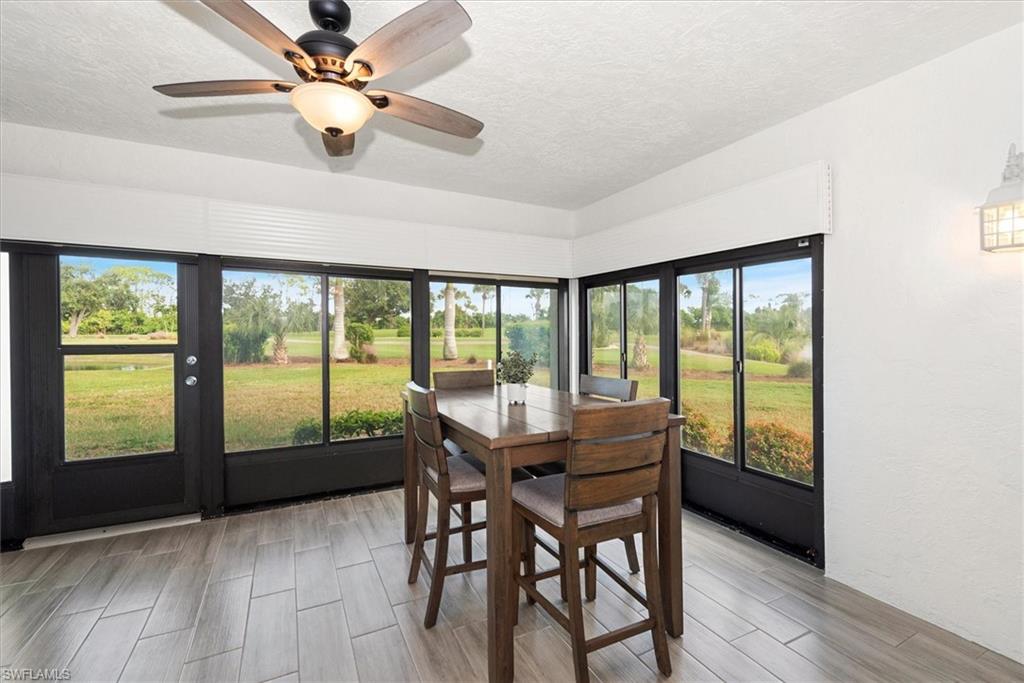 5665 Trailwinds Drive, Unit 616 Fort Myers, FL 33907 - Photo 13 of 29 a view of a dining room with furniture window and wooden floor