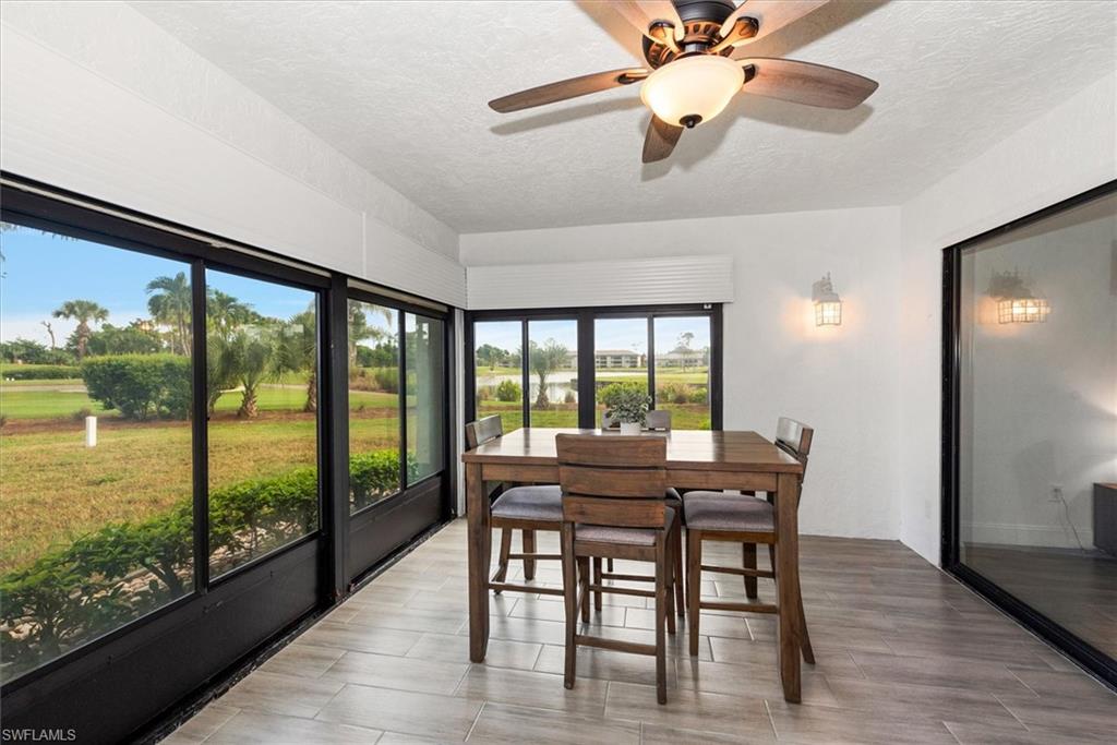 5665 Trailwinds Drive, Unit 616 Fort Myers, FL 33907 - Photo 14 of 29 a view of a dining room with furniture window and wooden floor