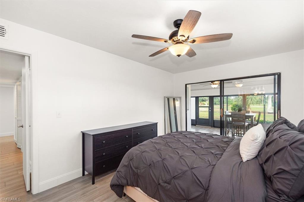 5665 Trailwinds Drive, Unit 616 Fort Myers, FL 33907 - Photo 20 of 29 a bedroom with a bed and a chandelier