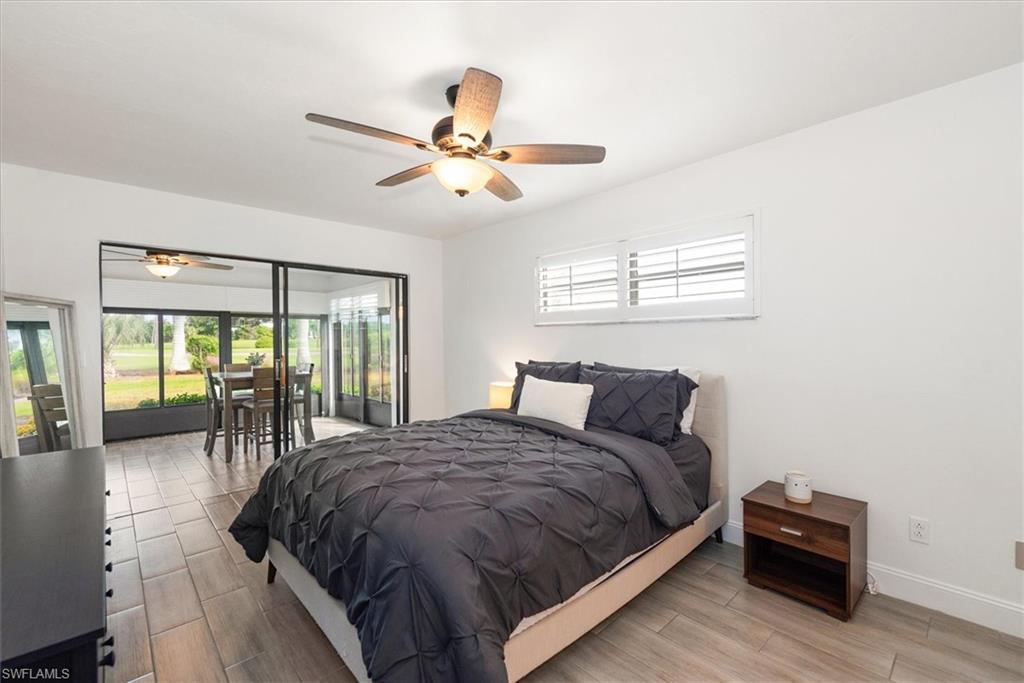 5665 Trailwinds Drive, Unit 616 Fort Myers, FL 33907 - Photo 22 of 29 a large bed sitting in a bedroom next to a window