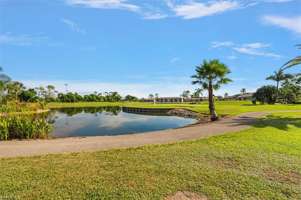 5665 Trailwinds Drive, Unit 616 Fort Myers, FL 33907 - Photo 24 of 29 a view of a lake with houses in the back