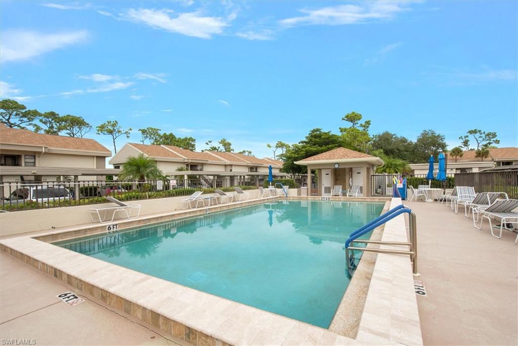 5665 Trailwinds Drive, Unit 616 Fort Myers, FL 33907 - Photo 27 of 29 a view of a swimming pool and lounge chairs