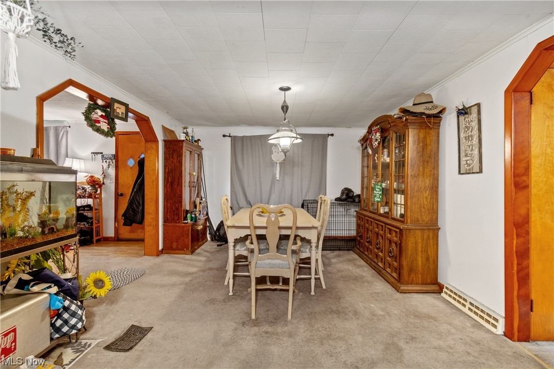 71300 Barton Road Bridgeport, OH 43912 - Photo 8 of 25 Dining area with crown molding and light carpet