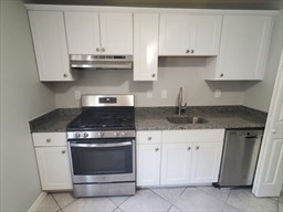 174 Pine Street, Unit 23 Holbrook, MA 02343 - Photo 2 of 25 a kitchen with granite countertop white cabinets and stainless steel appliances
