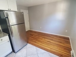 174 Pine Street, Unit 23 Holbrook, MA 02343 - Photo 4 of 25 a view of a kitchen with refrigerator and cabinet