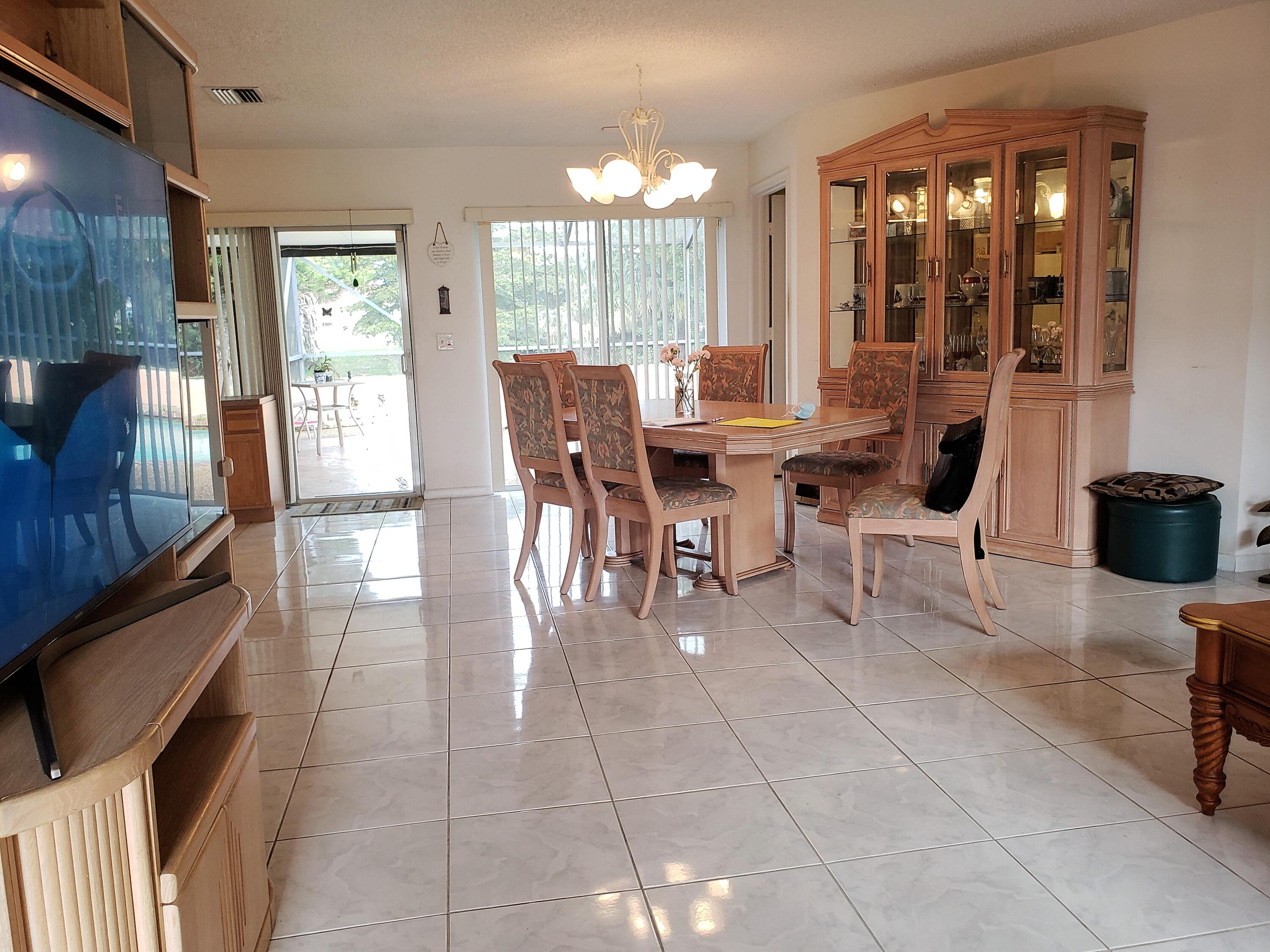 a view of a dining room with furniture and chandelier