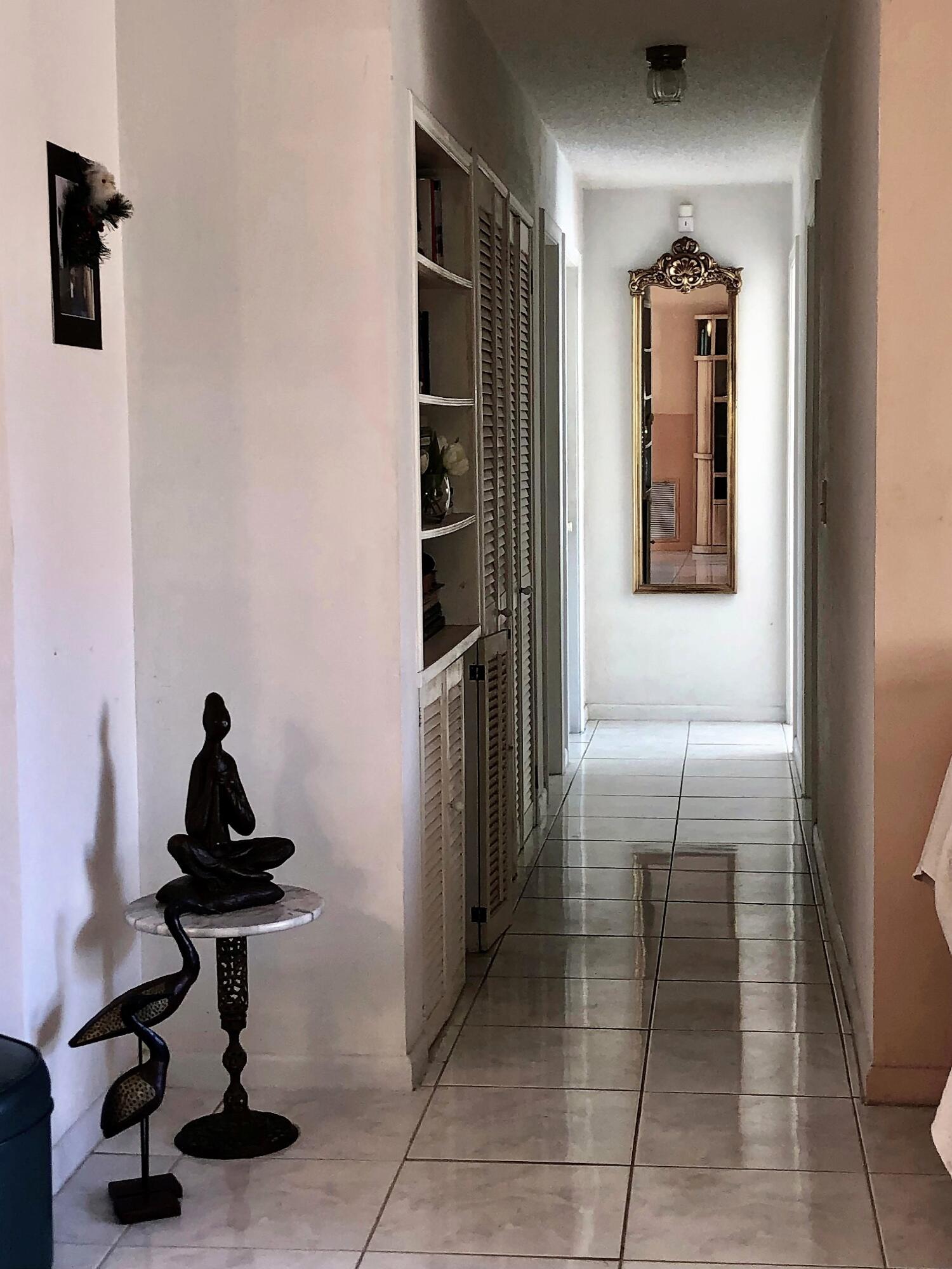 4535 Baldric Street Boca Raton, FL 33428 - Photo 11 of 19 a bedroom with a bed and a mirror