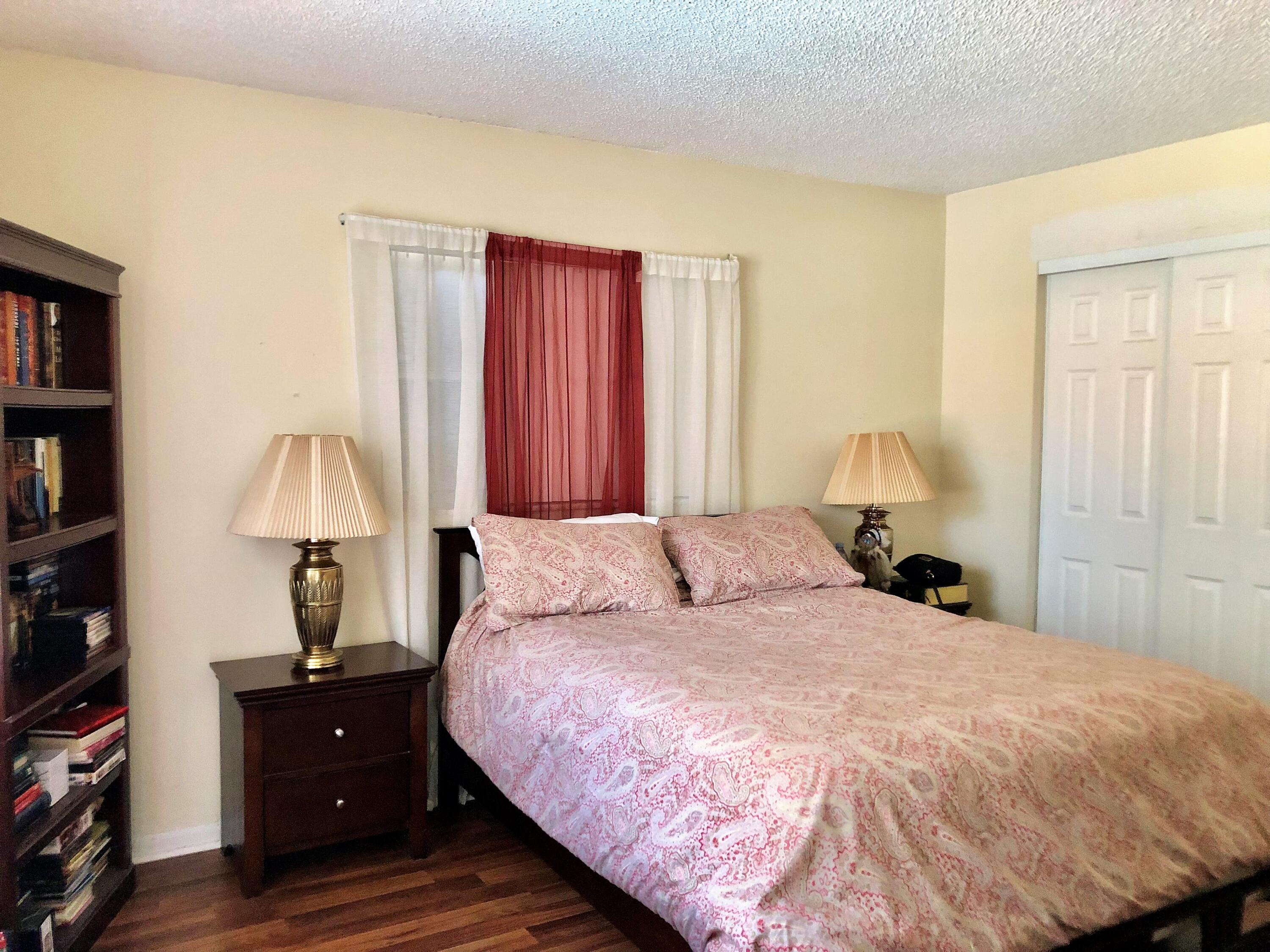 4535 Baldric Street Boca Raton, FL 33428 - Photo 13 of 19 a bedroom with a bed and a lamp