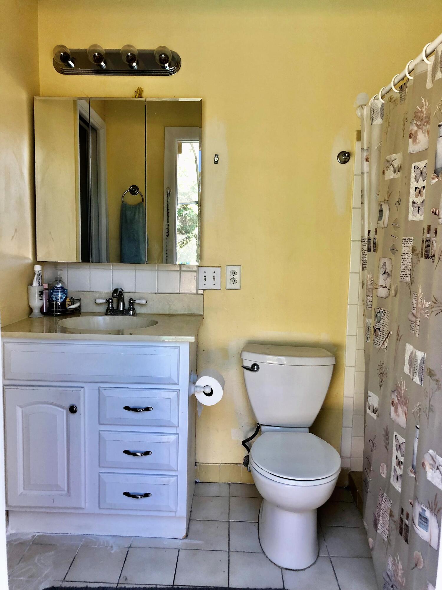 4535 Baldric Street Boca Raton, FL 33428 - Photo 14 of 19 a bathroom with a granite countertop toilet a sink and a mirror