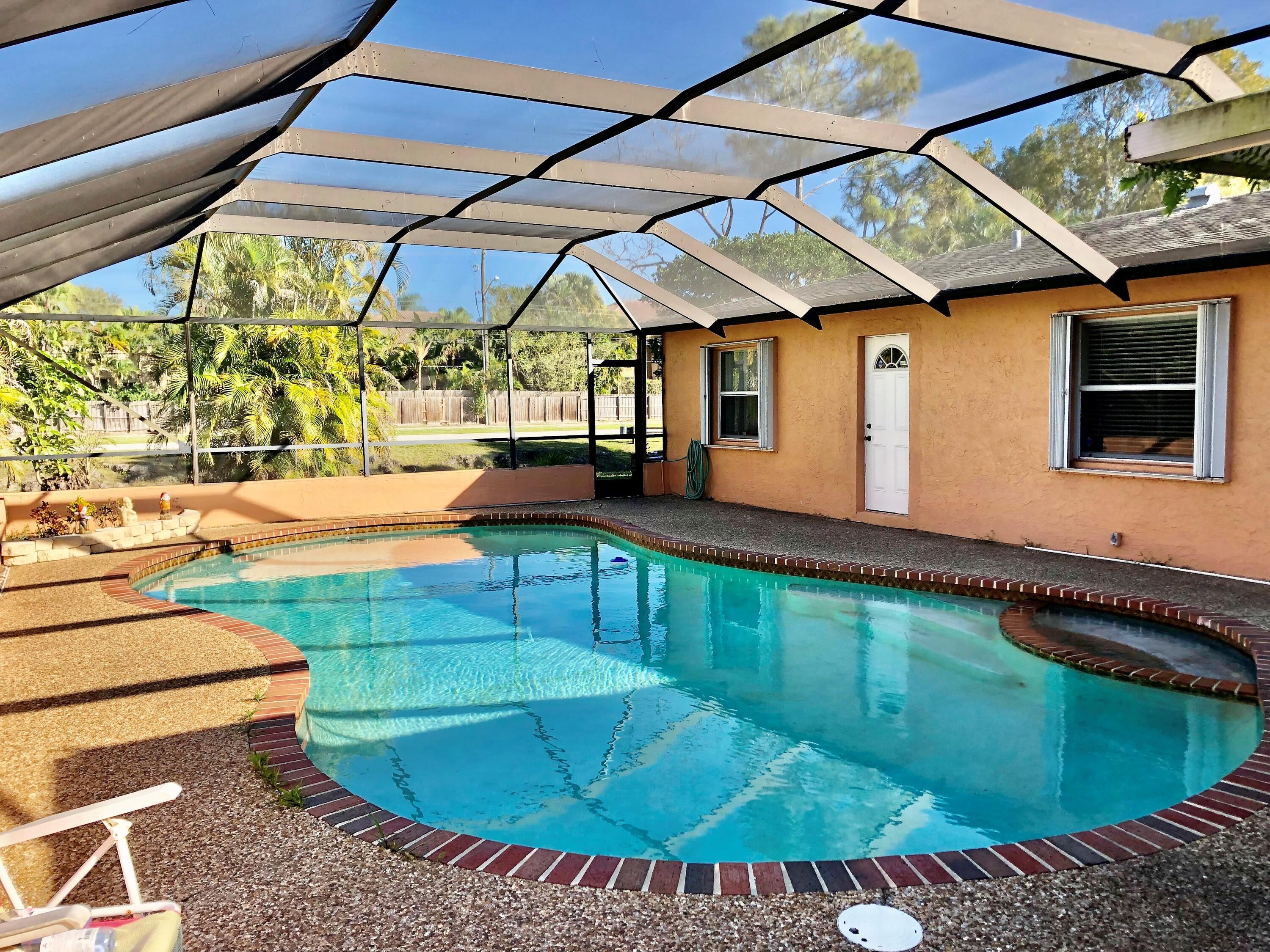 4535 Baldric Street Boca Raton, FL 33428 - Photo 16 of 19 a backyard of a house with yard and outdoor seating