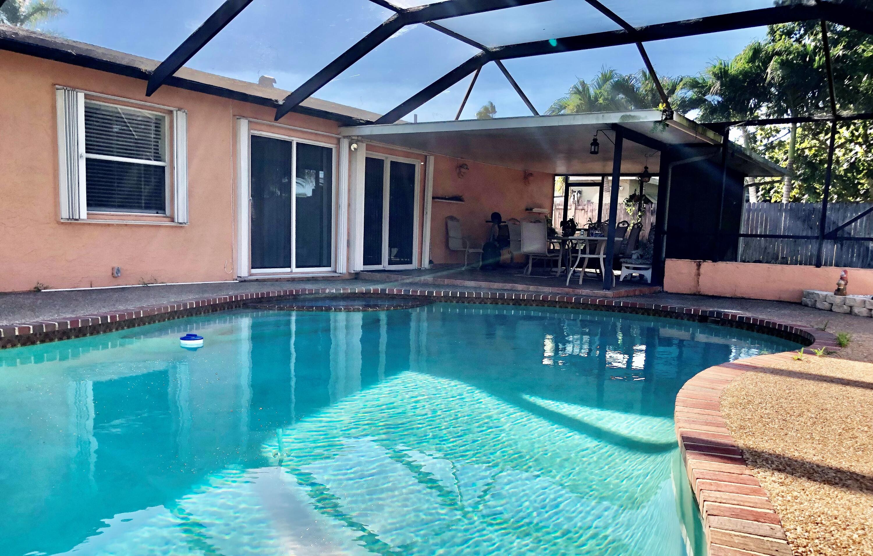 4535 Baldric Street Boca Raton, FL 33428 - Photo 17 of 19 a backyard of a house with yard table and chairs