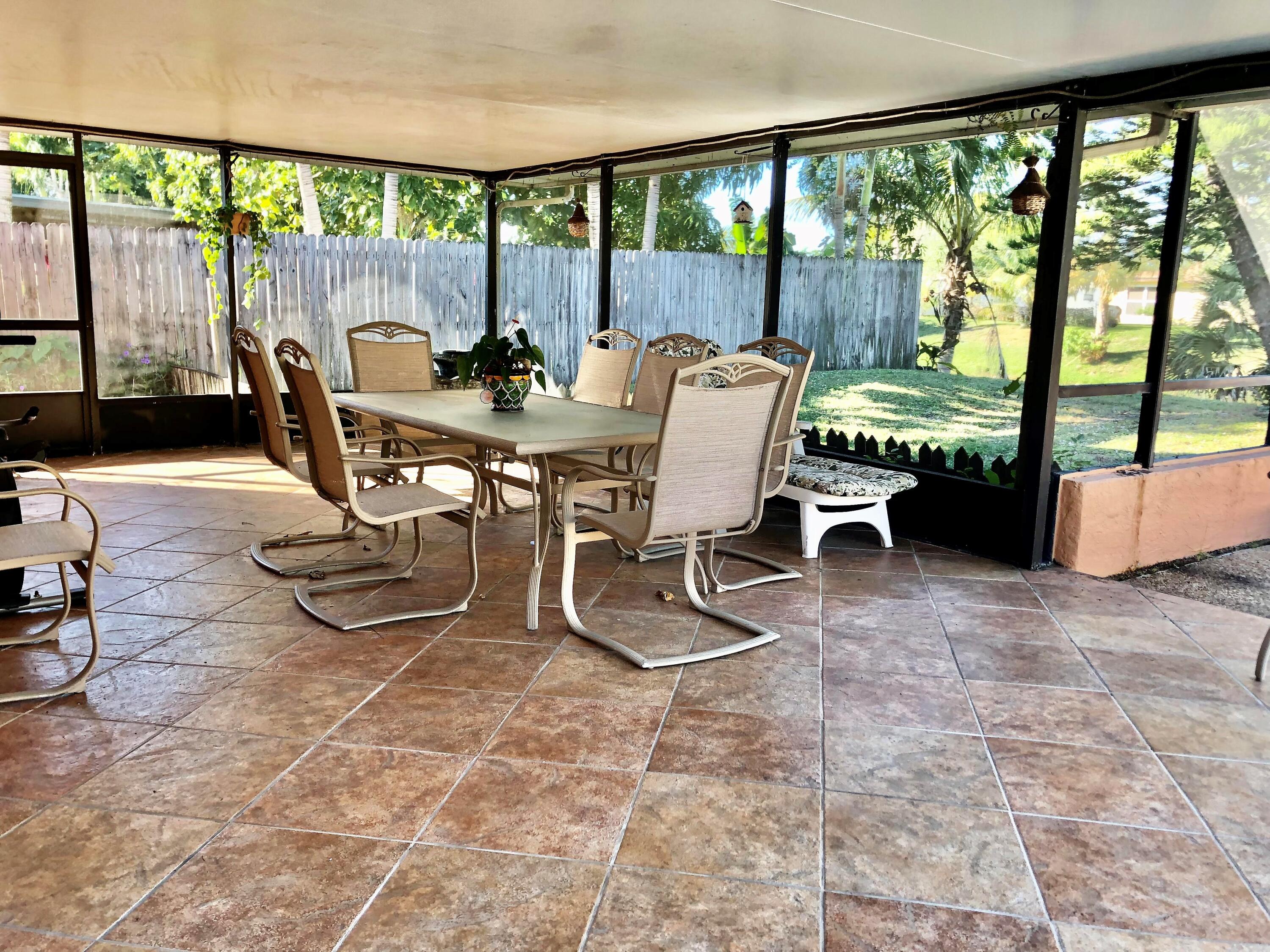4535 Baldric Street Boca Raton, FL 33428 - Photo 18 of 19 a dining room with furniture and large windows