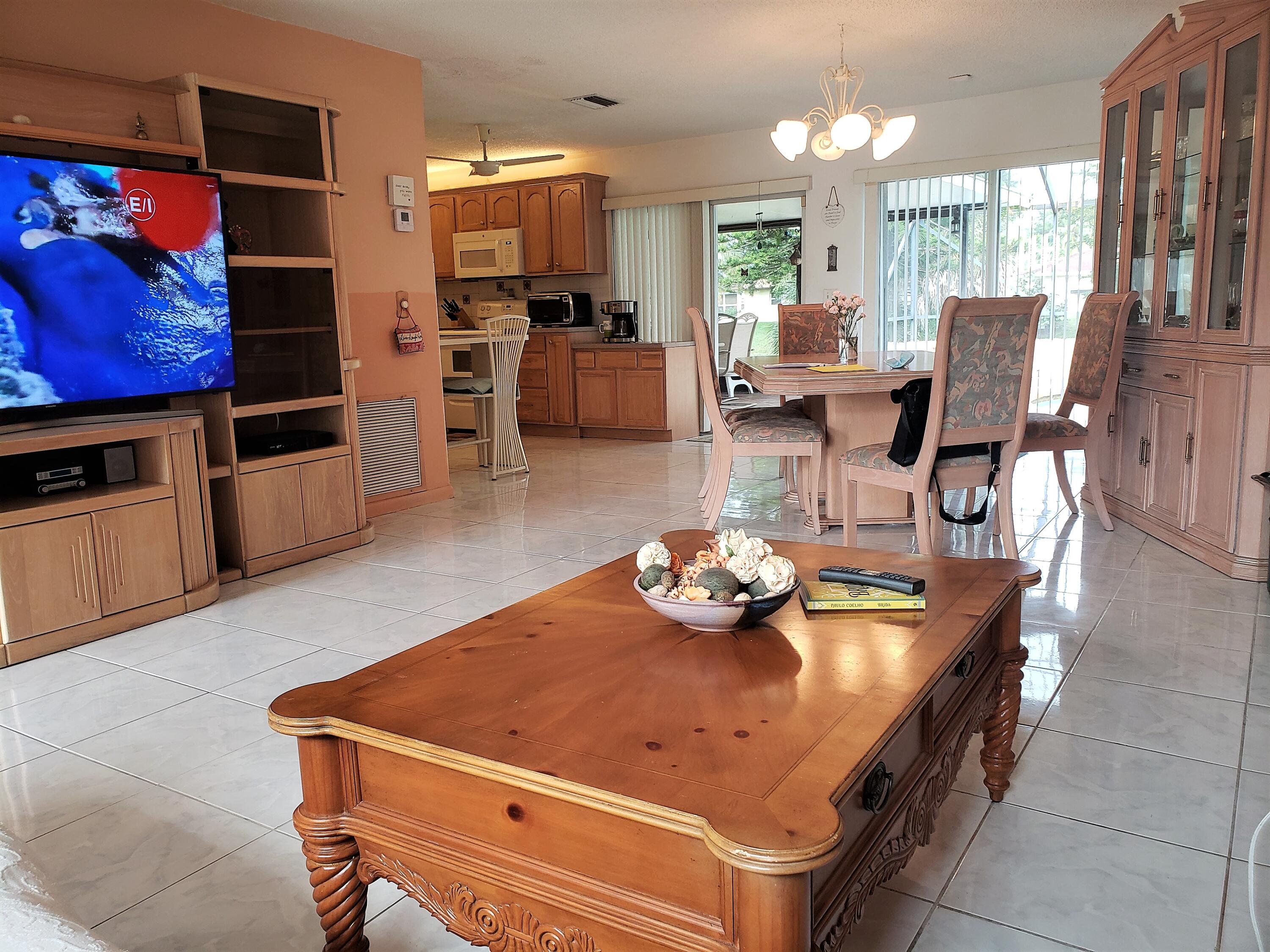 4535 Baldric Street Boca Raton, FL 33428 - Photo 4 of 19 a living room with furniture and flat screen tv