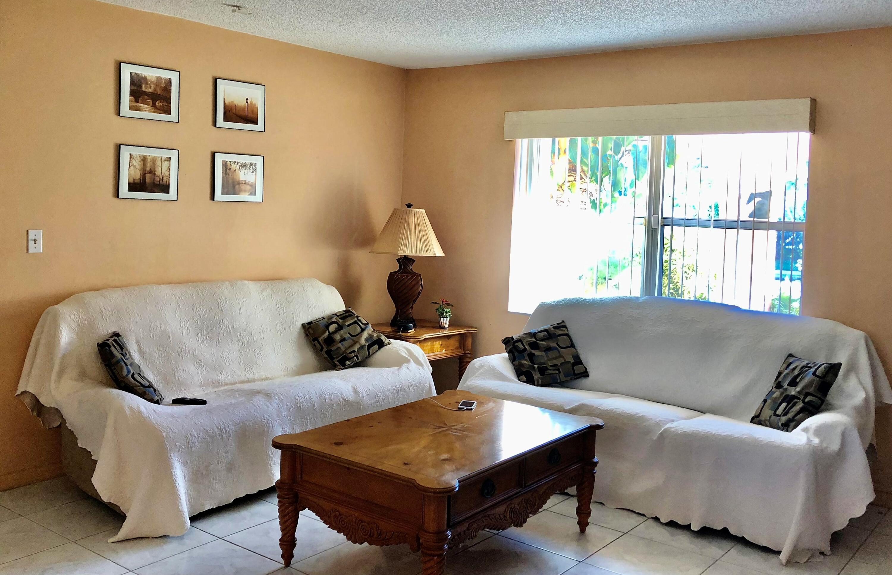 4535 Baldric Street Boca Raton, FL 33428 - Photo 5 of 19 a living room with furniture and a window