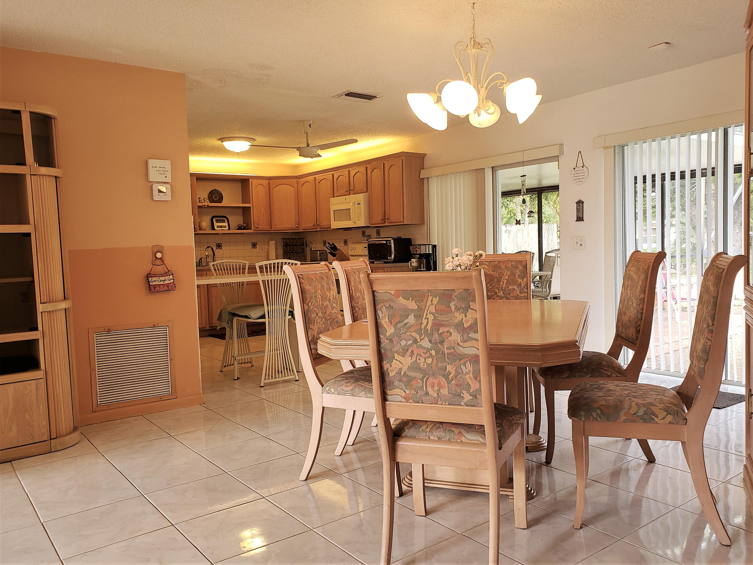4535 Baldric Street Boca Raton, FL 33428 - Photo 6 of 19 a view of a dining room with furniture and chandelier