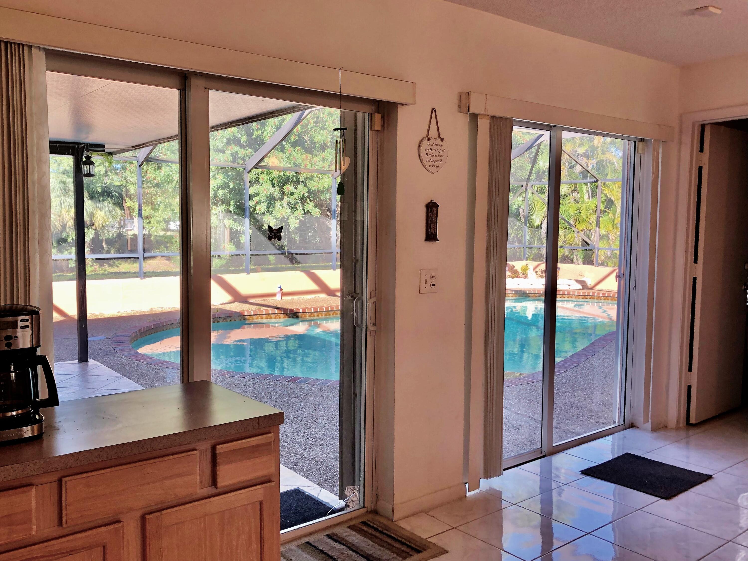 4535 Baldric Street Boca Raton, FL 33428 - Photo 10 of 19 a view of a living room and floor to ceiling window