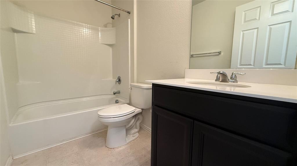 3312 Biggs Avenue Aubrey, TX 76227 - Photo 14 of 19 a bathroom with a sink a toilet and shower