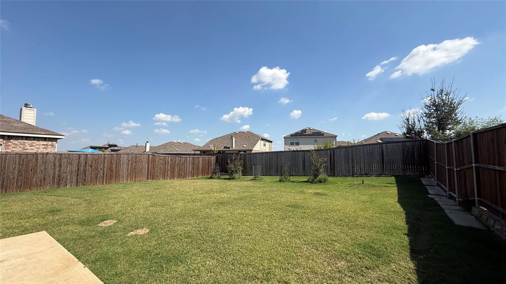 3312 Biggs Avenue Aubrey, TX 76227 - Photo 17 of 19 a view of a yard with a chair and wooden fence