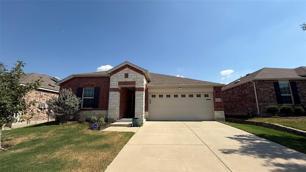 3312 Biggs Avenue Aubrey, TX 76227 - Photo 3 of 19 a front view of a house with a yard and garage