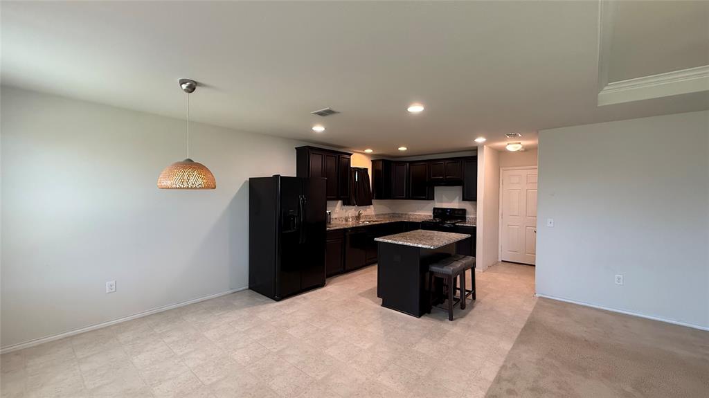 3312 Biggs Avenue Aubrey, TX 76227 - Photo 4 of 19 a kitchen with a refrigerator and a sink