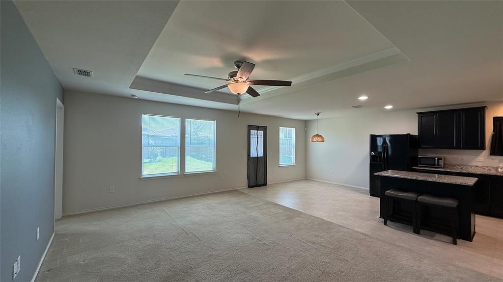 3312 Biggs Avenue Aubrey, TX 76227 - Photo 6 of 19 a view of a livingroom with furniture ceiling fan and a window