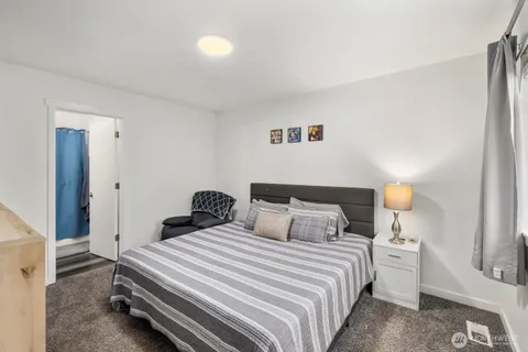 a bedroom with a bed and a lamp