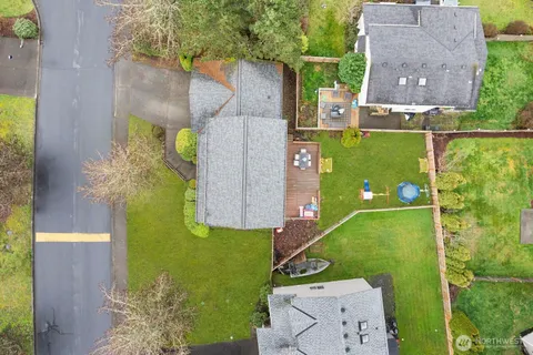 an aerial view of a house with a yard