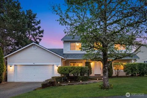 a front view of house with a garden