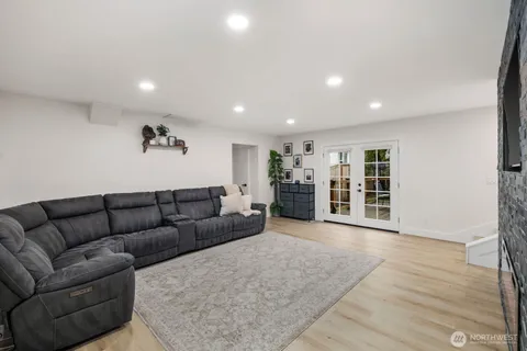 a living room with furniture and view of kitchen